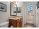 Bathroom featuring a vanity with a mirror and a door leading to a screened lanai at 19263 Quiet Oak Ln, Brooksville, FL 34604