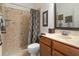Bathroom featuring tiled walk-in shower with glass door, vanity, and marble flooring at 19263 Quiet Oak Ln, Brooksville, FL 34604