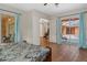 Bright bedroom with access to the outdoor space and views to another room with a piano at 19263 Quiet Oak Ln, Brooksville, FL 34604