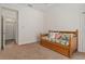 Bedroom featuring a twin bed with drawers and pillows and nearby bathroom and closet at 19263 Quiet Oak Ln, Brooksville, FL 34604