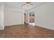Spacious bedroom featuring wood-style tile flooring, ceiling fan, and sliding glass doors to backyard at 19263 Quiet Oak Ln, Brooksville, FL 34604