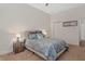 Comfortable carpeted bedroom featuring a ceiling fan, ensuite bathroom and closet at 19263 Quiet Oak Ln, Brooksville, FL 34604