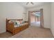 Bedroom featuring a twin bed with drawers and pillows, slider door leading to the lanai at 19263 Quiet Oak Ln, Brooksville, FL 34604