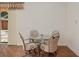 Cozy dining area with a glass table, four chairs, and a view of the backyard pool at 19263 Quiet Oak Ln, Brooksville, FL 34604