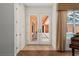 Inviting entryway showcasing double doors and natural light with view of the outdoor space and piano at 19263 Quiet Oak Ln, Brooksville, FL 34604