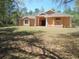 Single story home featuring a large well-maintained lawn and manicured landscaping at 19263 Quiet Oak Ln, Brooksville, FL 34604