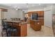 Well-equipped kitchen featuring granite countertops, an island with seating, and stainless steel appliances at 19263 Quiet Oak Ln, Brooksville, FL 34604