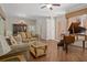Spacious open-concept living area with a grand piano, and seamless flow to the dining area at 19263 Quiet Oak Ln, Brooksville, FL 34604