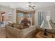 Cozy living area with tile floors, a grand piano, and large windows offering plenty of natural light at 19263 Quiet Oak Ln, Brooksville, FL 34604