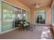 Enclosed patio offers privacy with sliding glass doors and seating area at 19263 Quiet Oak Ln, Brooksville, FL 34604