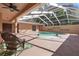 Covered pool area with a rock feature and a rocking chair at 19263 Quiet Oak Ln, Brooksville, FL 34604
