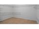 Spacious carpeted walk-in closet with multiple levels of wire shelving for storage at 19263 Quiet Oak Ln, Brooksville, FL 34604