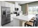 Modern kitchen with white cabinets, stainless steel appliances, a large island with bar seating and plenty of counter space at 20338 Lou Angela Ln, Lutz, FL 33558