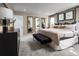 Elegant main bedroom featuring neutral tones, ample natural light, decorative mirrors, and stylish furnishings, creating a serene retreat at 20338 Lou Angela Ln, Lutz, FL 33558