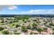 Aerial view showcasing a picturesque residential community with multiple ponds and mature trees at 2245 Greenwich Dr # 66, Sun City Center, FL 33573