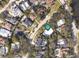An aerial view of a residential neighborhood with lush greenery and a home with a white roof at 2606 S Hawthorne Cir, Tampa, FL 33629