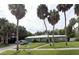 A nicely landscaped home with palm trees, a well-kept lawn, and an attached two-car garage at 2606 S Hawthorne Cir, Tampa, FL 33629