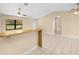 Living room with breakfast bar, tile flooring, vaulted ceiling and large window at 28089 Old Trilby Rd, Brooksville, FL 34602