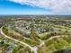 Panoramic aerial view of a golf course community with lakes, lush landscaping, and well maintained homes at 3555 Sylvan Edge Dr, Palm Harbor, FL 34685