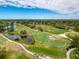 Aerial view of the lush community golf course with well manicured greens and picturesque scenery at 3555 Sylvan Edge Dr, Palm Harbor, FL 34685