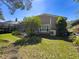 Well-maintained backyard with lush green grass, mature trees, and a screened enclosure in a peaceful setting at 3555 Sylvan Edge Dr, Palm Harbor, FL 34685