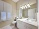 Bright bathroom with white vanity and tiled shower-tub combo at 3555 Sylvan Edge Dr, Palm Harbor, FL 34685