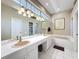 Bright bathroom features double vanity, soaking tub, and separate shower at 3555 Sylvan Edge Dr, Palm Harbor, FL 34685