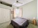 Bedroom with green carpet, ceiling fan and natural light from windows at 3555 Sylvan Edge Dr, Palm Harbor, FL 34685