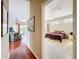 Hallway view of a living room and primary bedroom with en-suite bathroom and walk in closet at 3555 Sylvan Edge Dr, Palm Harbor, FL 34685