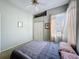 Light-filled bedroom with ceiling fan, closet, and natural light at 3555 Sylvan Edge Dr, Palm Harbor, FL 34685