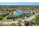 Aerial view showcasing the community amenities including a pool, tennis courts, and clubhouse at 3555 Sylvan Edge Dr, Palm Harbor, FL 34685