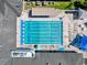 Overhead view of a sparkling community pool with lap lanes, lounge chairs, and surrounding amenities at 3555 Sylvan Edge Dr, Palm Harbor, FL 34685