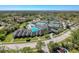 Aerial view of the community center featuring a pool, tennis courts, and landscaped grounds at 3555 Sylvan Edge Dr, Palm Harbor, FL 34685
