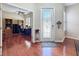 Foyer with decorative glass front door, wood floors, and view to an office space at 3555 Sylvan Edge Dr, Palm Harbor, FL 34685