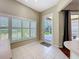 Bright kitchen with view to a patio or yard through a glass door and shuttered windows at 3555 Sylvan Edge Dr, Palm Harbor, FL 34685