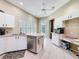 Corner kitchen view with white cabinets, stainless dishwasher, and lots of natural light at 3555 Sylvan Edge Dr, Palm Harbor, FL 34685