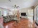 Inviting living area with hardwood floors, ceiling fan, and open layout, perfect for relaxing or entertaining at 3555 Sylvan Edge Dr, Palm Harbor, FL 34685