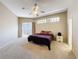 Bright main bedroom featuring a ceiling fan and sliding glass doors for outdoor access at 3555 Sylvan Edge Dr, Palm Harbor, FL 34685