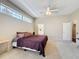 Bedroom with high ceilings, ceiling fan, large windows, and neutral carpet at 3555 Sylvan Edge Dr, Palm Harbor, FL 34685