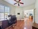 Office with a ceiling fan, wood floors, and a view of the entry to dining and living area at 3555 Sylvan Edge Dr, Palm Harbor, FL 34685