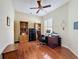 Well-lit office space featuring wood floors, built-in bookshelves, and neutral paint at 3555 Sylvan Edge Dr, Palm Harbor, FL 34685