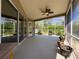 Spacious screened porch with ceiling fan and a view of the yard at 3555 Sylvan Edge Dr, Palm Harbor, FL 34685