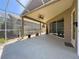 Spacious screened porch with fan and access to the backyard at 3555 Sylvan Edge Dr, Palm Harbor, FL 34685