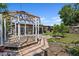 Spacious backyard with a wooden deck under a gazebo, walkway, and lush greenery at 3728 Linkwood St, New Port Richey, FL 34652