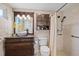 Updated bathroom with decorative vanity, tiled shower, and built-in storage at 3728 Linkwood St, New Port Richey, FL 34652