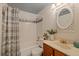 Cozy bathroom featuring a shower-tub combo, updated fixtures, and decorative accents at 3728 Linkwood St, New Port Richey, FL 34652