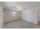 Bright bedroom featuring neutral walls, plush carpeting, a ceiling fan, and a closet at 3728 Linkwood St, New Port Richey, FL 34652
