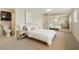 Bright bedroom featuring a large bed, mirrored closet, and en-suite bathroom at 3728 Linkwood St, New Port Richey, FL 34652
