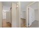 Hallway featuring laminate floors connecting rooms, closet storage, and bright lighting at 3728 Linkwood St, New Port Richey, FL 34652