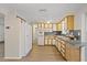 Bright kitchen featuring ample cabinet space, modern appliances, and laminate floors at 3728 Linkwood St, New Port Richey, FL 34652